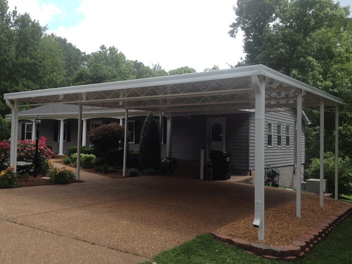 White aluminum carport over pebble driveway